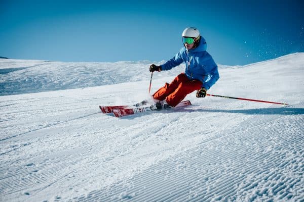 Jeune skieur qui dévale un pente pendant un séjour ski